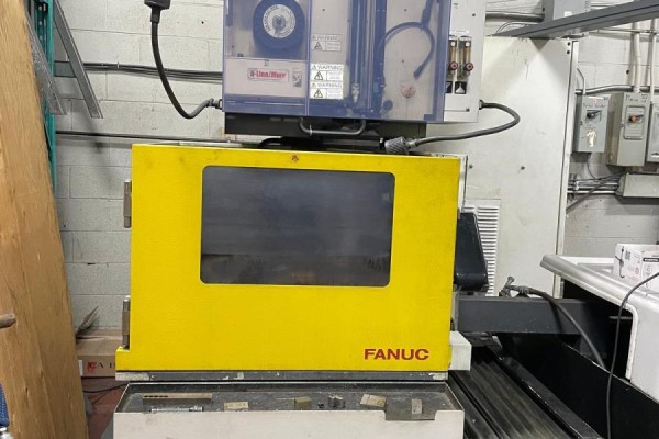 A bright yellow FANUC machine with a glass window and control panel, set on a workbench. - 236 Canarctic Drive, Toronto
