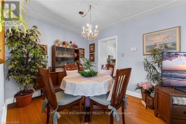 Kitchen with white cabinets, beige tiled floor, and a window overlooking the backyard. - 236 Pine Cove Road, Burlington