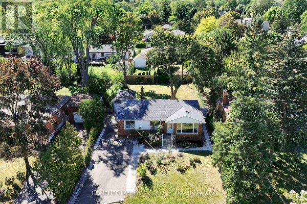 Aerial view of a brick bungalow on a tree-lined residential street. - 236 Southview Road, Oakville