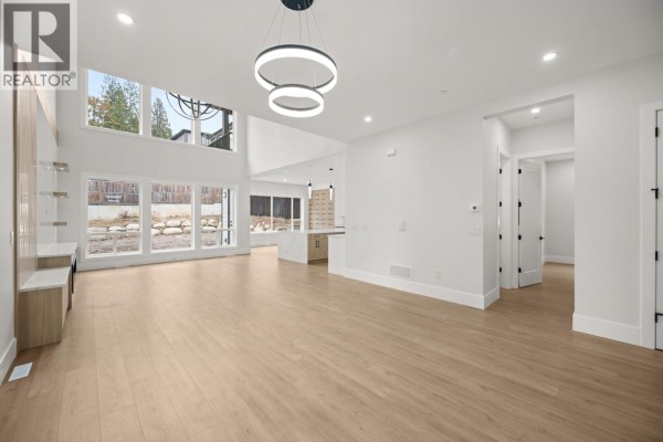 Spacious room with high ceilings, large windows, and light wood flooring - 23685 131a Avenue, Maple Ridge