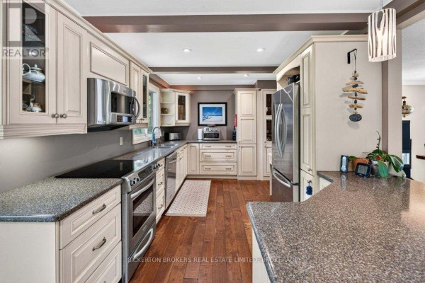 Cream cabinets, granite counters, stainless steel appliances, and wood floors in kitchen - 237 Old River Road Leeds And The Thousand Islands