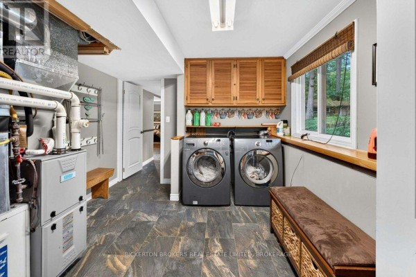 Washer, dryer, wood cabinets, and bench seating in laundry room - 237 Old River Road Leeds And The Thousand Islands