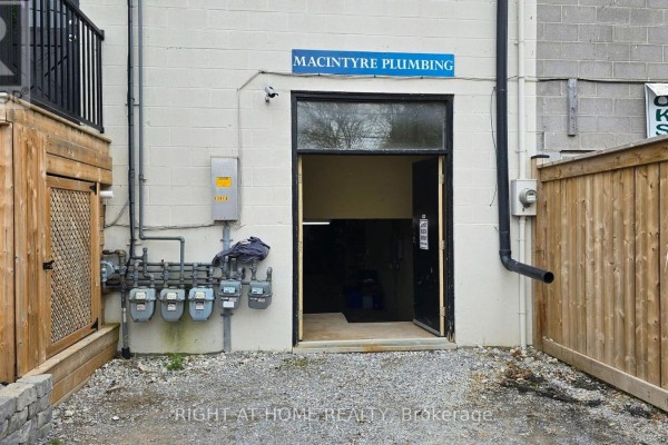Exterior view with open double doors showing the interior of a commercial space. - 237 Queen Street, Scugog