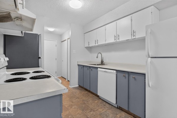 Kitchen with white cabinets, grey lower cabinets, sink, dishwasher, and refrigerator. - 237 Woodvale Rd Nw, Edmonton