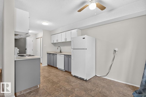 Kitchen with stove, refrigerator, sink, dishwasher, white upper cabinets, and grey lower cabinets. - 237 Woodvale Rd Nw, Edmonton