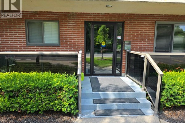 Entrance steps to a brick building with glass doors and railings. - 2373 King Street E Unit# 37, Hamilton