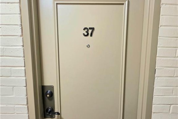 A closed beige apartment door with the number 37 and a peephole. - 2373 King Street E Unit# 37, Hamilton