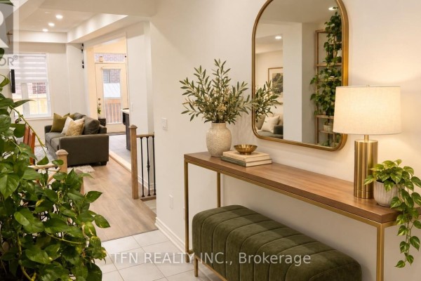 Entryway with a console table, mirror, bench, and houseplants, with a view into the living room. - 238 Skinner Road, Hamilton