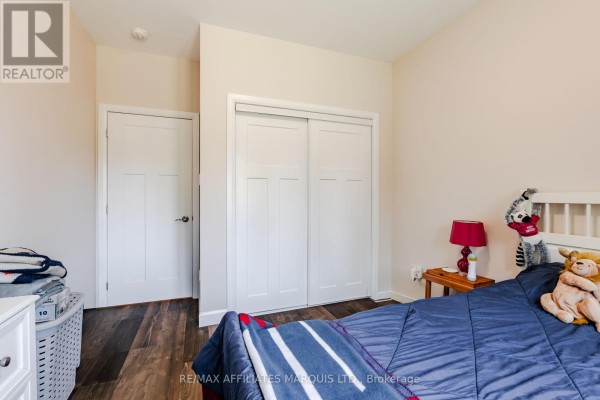 Bedroom with sliding closet, bed, and nightstand - 2389 Watson Crescent Cornwall