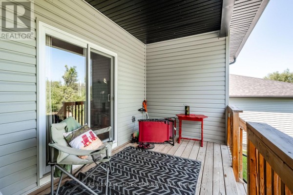 Deck with chairs, rug, and red table - 2389 Watson Crescent Cornwall