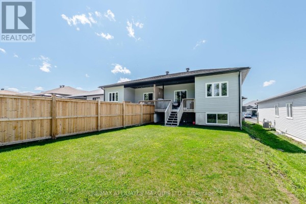 Backyard with wooden fence, deck, and lawn - 2389 Watson Crescent Cornwall