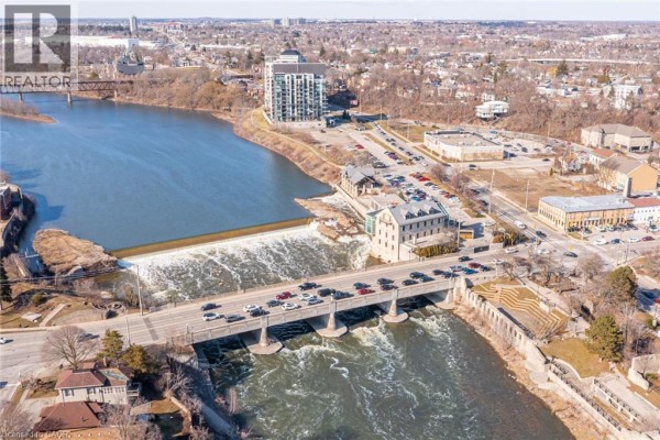 River, dam, and bridge with buildings and cars - 239 Cranbrook Street Kitchener