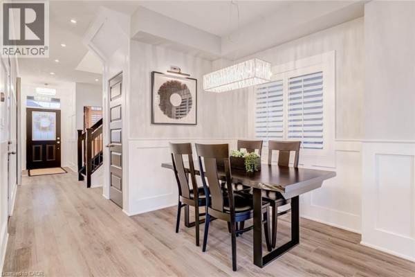 Dark wood dining table and chairs with a modern chandelier - 239 Cranbrook Street Kitchener