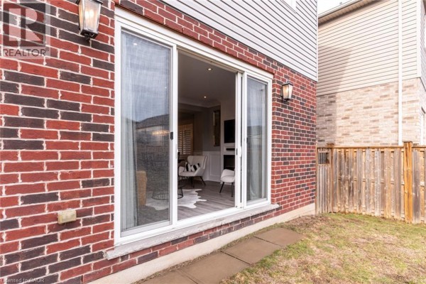 Sliding glass doors with brick exterior and wooden fence - 239 Cranbrook Street Kitchener