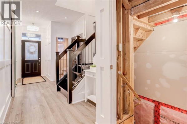 Hallway with front door, modern stairs, and unfinished construction - 239 Cranbrook Street Kitchener