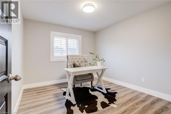 Home office with white desk, tufted chair, cowhide rug - 239 Cranbrook Street Kitchener