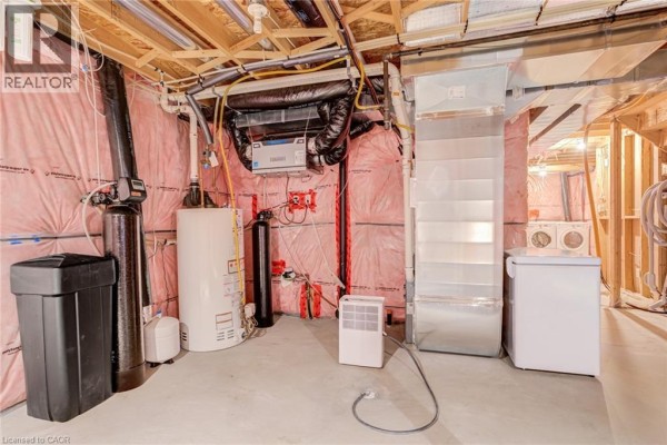 Basement with water heater, water softener, furnace, washer, dryer, and freezer - 239 Cranbrook Street Kitchener
