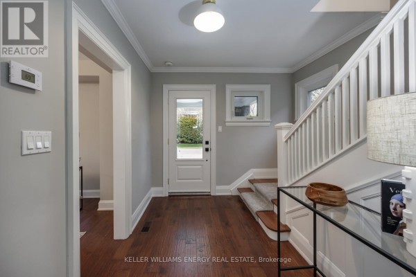 Interior foyer with hardwood floors, a staircase, and a door leading outside. - 239 Perry Street, Scugog