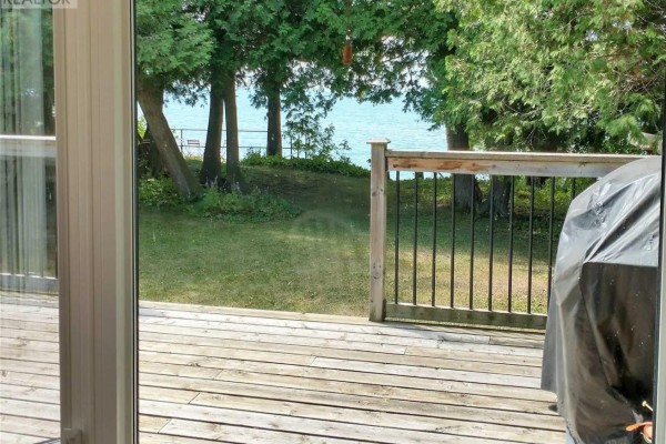 Wooden deck with lake view and grill cover - 2392 Lakeshore Drive Ramara