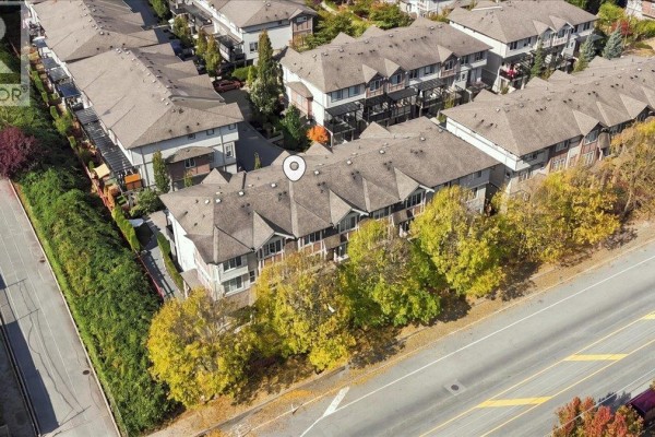 Aerial view of a townhouse complex with multiple units and parked cars. - 24 10151 240 Street, Maple Ridge