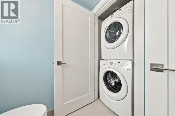 Stacked white front-loading washing machine and dryer in a closet. - 24 10151 240 Street, Maple Ridge