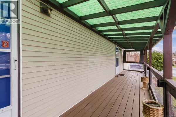 Living room with large windows, ceiling fan, and hardwood flooring - 24 7021 Grant Rd W, Sooke