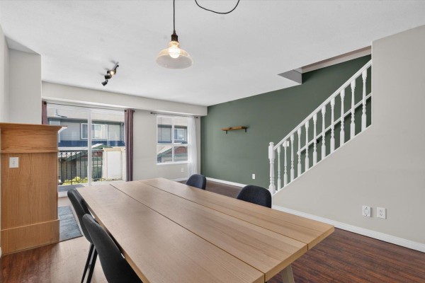 White kitchen with wood countertops, white appliances, hexagonal backsplash, and dark wood floors. - 24 9470 Hazel Street, Chilliwack Proper East, Chilliwack