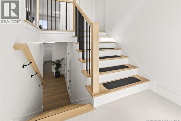 Staircase with wooden steps, black railing, and carpeted treads - 24 Adéo-rose, Memramcook