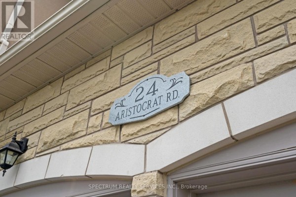Close-up of the stone facade showing the house number 24 Aristocrat Road. - 24 Aristocrat Road, Brampton