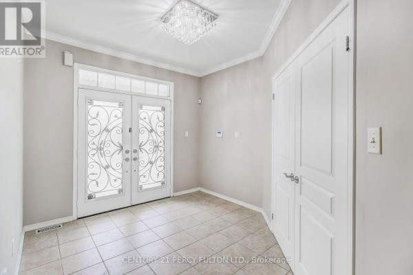 Foyer with tiled floor, double doors, and a decorative chandelier. - 24 Bellhouse Place, Whitby