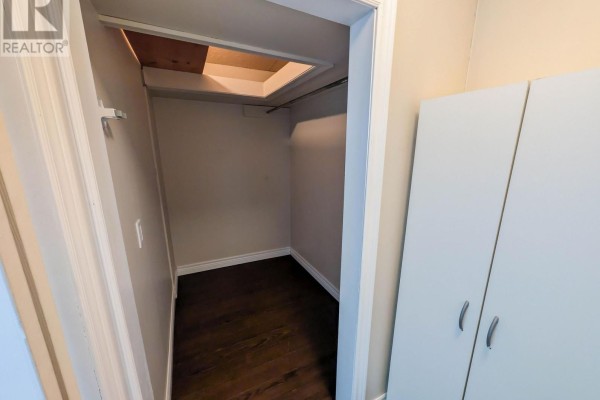 Storage closet with attic access and dark hardwood floors - 24 Churchill Street St Catharines