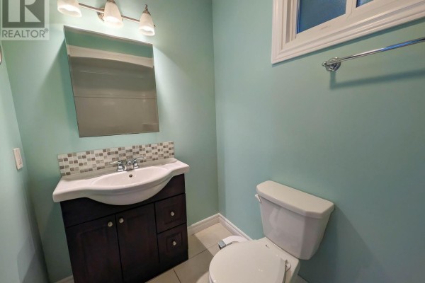 Bathroom with vanity, sink, mirror, and toilet - 24 Churchill Street St  Catharines