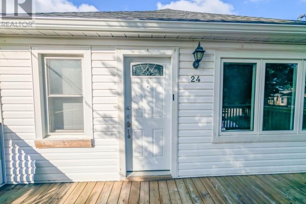 White front door and windows with a wooden deck - 24 Churchill Street St Catharines