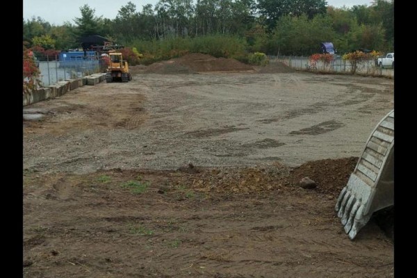 Vacant industrial lot with gravel, dirt, and construction equipment. - 24 Commerce Park Drive, Innisfil