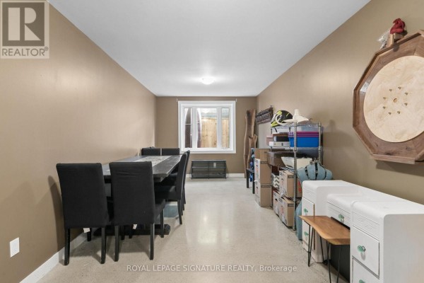 Dining area with table and chairs, storage shelves, and circular wall decor - 24 Davidson Street Cambridge