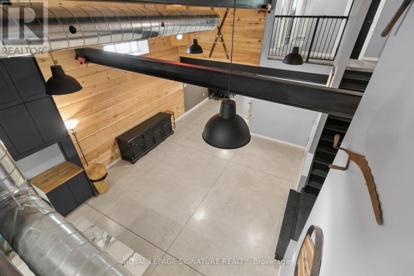 Industrial living room with exposed ductwork and pendant lights - 24 Davidson Street Cambridge