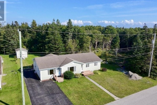Aerial view of the semi-detached bungalow showing the side and back with surrounding trees. - 24 Millennium Drive, Kippens