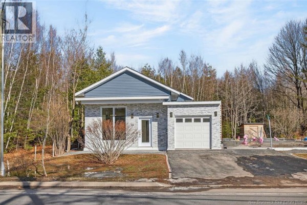 Open kitchen with dark cabinetry, white island, and large windows - 24 Murray Avenue, Fredericton