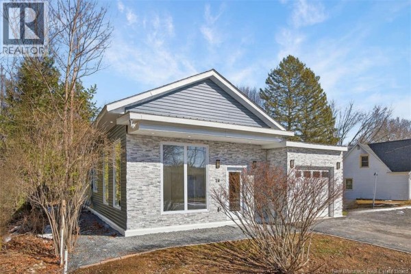 Bathroom with a wooden vanity, marble flooring, and access to another room - 24 Murray Avenue, Fredericton