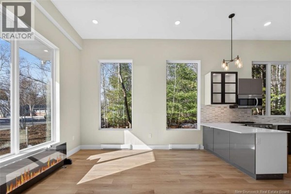 Empty garage with stone exterior and concrete flooring - 24 Murray Avenue, Fredericton
