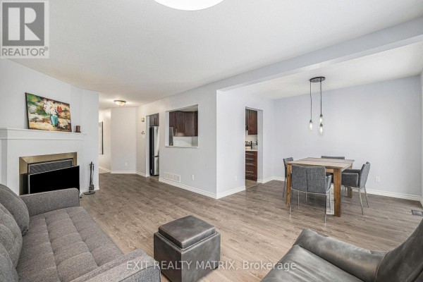 Close-up of kitchen featuring modern appliances, dark cabinetry, and tile flooring - 24 Oakhaven Private, Ottawa