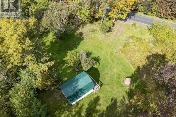 Overhead view of small green roof building on grassy lot surrounded by trees. - 24 Old Post Road, Smiths Cove