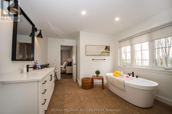 Bathroom with double vanity, soaking tub, and large windows - 24 Rory Drive Selwyn