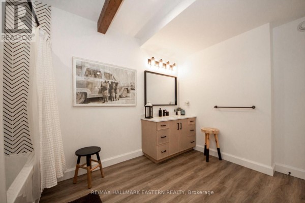 Modern bathroom with vanity, tub, wooden beams, and artwork - 24 Rory Drive Selwyn