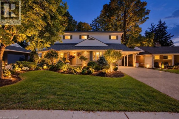 Close-up of the house entrance with a stone facade and decorative landscaping. - 24 Valewood Place, Kitchener