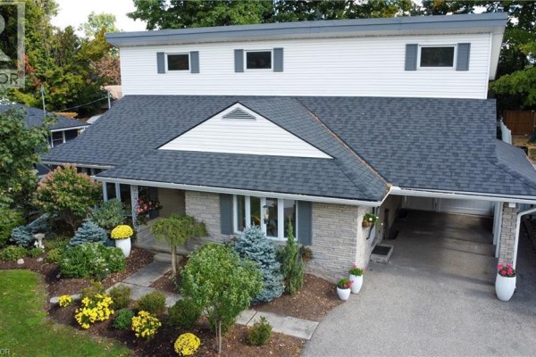 Aerial view of the house showing the roof, driveway, and surrounding greenery. - 24 Valewood Place, Kitchener