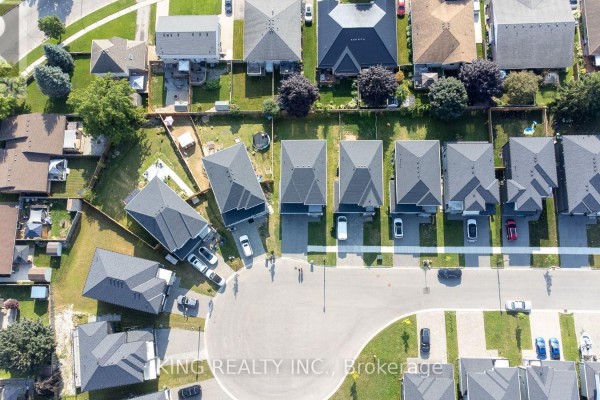 Aerial view of curved suburban street lined with contemporary houses and manicured yards. - 24 Welch Court, St  Thomas
