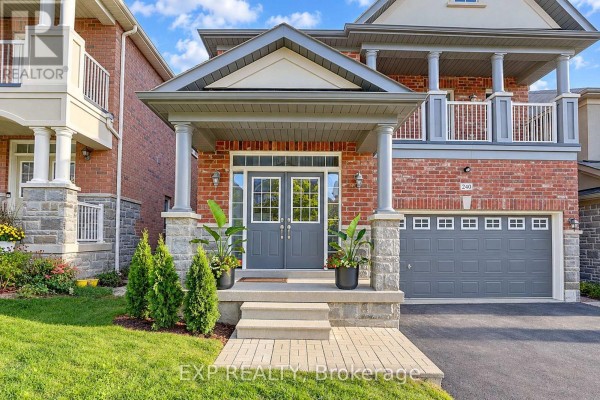 Close-up of the front entrance with double doors, stone pillars, and manicured landscaping. - 240 Aspenwood Drive, Newmarket