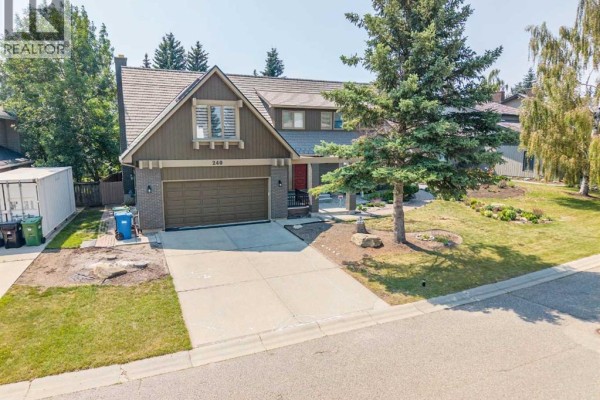 Aerial view of the house at 240 Canterville Drive Sw, Calgary, surrounded by other homes. - 240 Canterville Drive Sw, Calgary