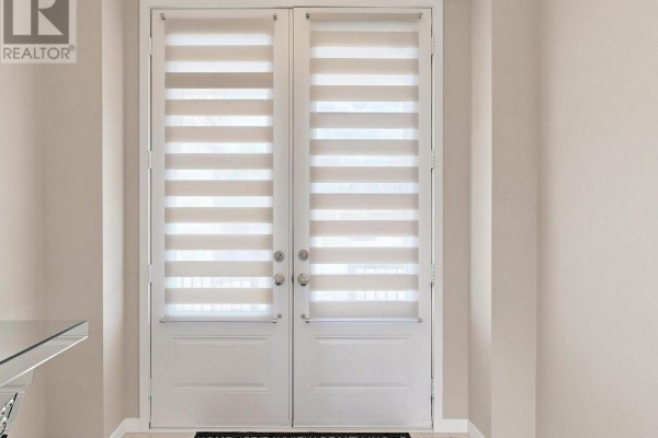 Interior view of a double door with horizontal blinds and silver hardware. - 240 Elyse Court, Aurora